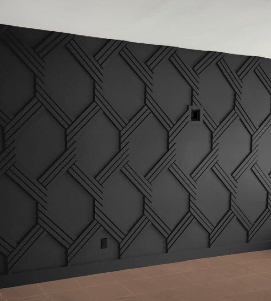Dark charcoal wall with a raised three-dimensional geometric pattern of interlocking lines.