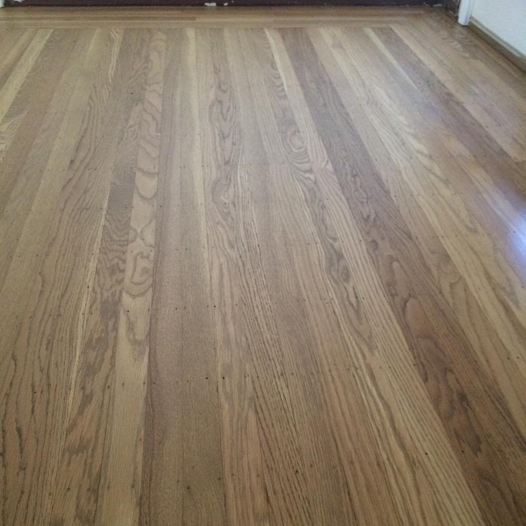 Light brown hardwood floor planks with visible natural wood grain patterns.