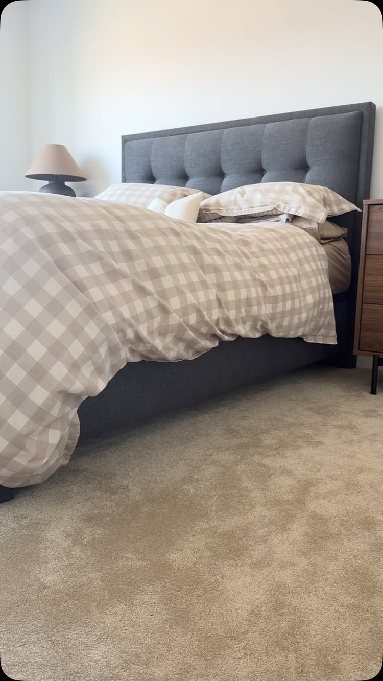 11 Whole House Flooring Ideas That Work from Entry to Bedroom 6 Beige wall-to-wall carpet covering the floor of a bedroom with a large bed.